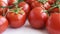 Healthy food ingredient - raw tomatoes on white background, vibrant colours