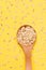 Healthy food. Muesli for breakfast. Wooden spoon. Yellow background