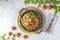 Healthy food. Pan of baking chicken meat, fried sweet potato and brussels sprouts. Top view, light gray concrete surface, flat lay