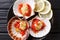 Healthy food seafood: scallops in a shell with sauce, tomatoes a