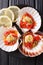 Healthy food seafood: scallops in a shell with sauce, tomatoes a