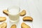 Healthy food, sour yogurt in a glass cup and crackers with raisins on a white table, space for text