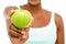 Healthy food tastes real good. Studio shot of an unrecognisable woman eating a green apple against a studio background.