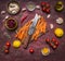 Healthy foods, cooking and vegetarian concept cutting board with a knife and sliced carrots around lie ingredients on wooden rusti