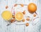 Healthy foods morning juice from oranges and kumquat, fruits are laid out on a white napkin, a glass filled with juice, on a woode