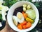 Healthy foods in the white bowl hold in my hand in backyard.