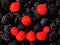 Healthy and fresh breakfast with berries assortment. Human mimic shape made by red and black raspberries. Colorful fruit