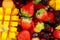 Healthy fresh fruit on wooden table. Delicious summer meal: strawberries, blueberries, oranges, kiwi