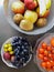 Healthy and fresh various fruit in a bowl on the table top view, grapes, apples, bananas healthy lifestyle