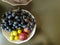 Healthy and fresh various fruit in a bowl on the table top view, grapes, apples, bananas healthy lifestyle
