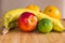 A healthy fruit arrangement with a nectarine, lime, bananas, oranges.