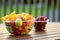 a healthy fruit bowl near junk food packages