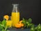 Healthy fruit drink. Natural fresh squeezed orange or tangerine juice in a glass bottle with water drops and fresh green mint
