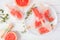 Healthy grapefruit and thyme popsicles, above view table scene against white wood