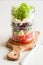 Healthy greek salad in mason jar. tomato olive feta onion