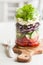 Healthy greek salad in mason jar. tomato olive feta onion