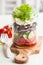 Healthy greek salad in mason jar. tomato olive feta onion