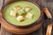 Healthy green cream broccoli soup with dried