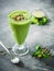 Healthy green smoothie with spinach, banana and pumpkin seeds.