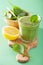 Healthy green smoothie with spinach leaves apple lemon