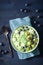 Healthy green spinach smoothie bowl with blueberry, apple stars, kiwi, chia seed