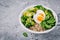 Healthy green vegetarian buddha bowl lunch with eggs, quinoa, spinach, avocado, grilled brussels sprouts and broccoli with flax se