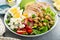 Healthy grilled chicken lunch bowl with chickpeas and feta