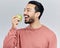 Healthy, happy and an Asian man eating an apple isolated on a white background in a studio. Smile, food and a Chinese