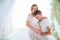 Healthy happy pregnancy. Her husband gently hugs belly of pregnant wife