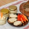 Healthy homemade creamy hummus with vegatables and bread