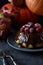 Healthy homemade dessert. Traditional steam pudding with chocolate glaze and berries and winter squashes on black background
