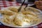 Healthy homemade dumplings lying on a white plate with knife and fork