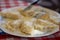 Healthy homemade dumplings lying on a white plate with knife and fork