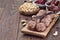 Healthy homemade energy balls with cranberries, cashew nuts, dates and vanilla on a wooden plate, horizontal, copy space