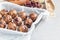 Healthy homemade energy balls with cranberries, nuts, dates and rolled oats, copy space