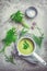 Healthy homemade green herb soup in pot made from local wild and garden herbs