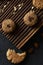 Healthy homemade sweets. Vegan almond bited with chocolate drops and oatmeal cookies on ribbed oak board on black background