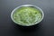 Healthy Indian Green Chutney or Sauce Made using Coriander, Mint And Spices. isolated over moody background. Selective focus