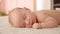 Healthy infant sleeping at home. Beautiful small baby sleeping. Close-up of infant sleeping. Macro shot of a small caucasian baby