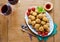 Healthy Italian Appetizer with Risotto Balls Arancini , green Olives , tomato and red WineSicilian homemade Snack