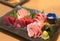 Healthy Japanese fish dish of an assortment of sliced pieces of tuna maguro sashimi in plate.