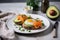 Healthy keto breakfast with eggs, salmon and avocado on a plate, restaurant serving. Generative AI