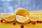 Healthy lemon slices with fresh red berries on the wooden table with free blurred copy space. Ingredients for juice or detox drink