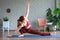 Healthy life. Attractive woman practicing home yoga, working out, wearing sportswear