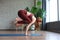 Healthy life. Attractive woman practicing home yoga, working out, wearing sportswear