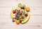 Healthy lifestyle background with various colorful fruit, laid out in the center the white wooden table top view