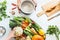 Healthy lifestyle concept. Female hand prepare various colorful organic farm vegetables on white desk background with cooking pot