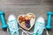 Healthy lifestyle concept with food in heart and sports fitness accessories