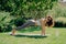 Healthy lifestyle concept. Horizontal shot of motivated fitness woman in active wear poses in plank pose on fitness mat exercises