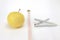 Healthy lifestyle concept. Measuring tape with a yellow apple and cigarettes on a white background. Isolate